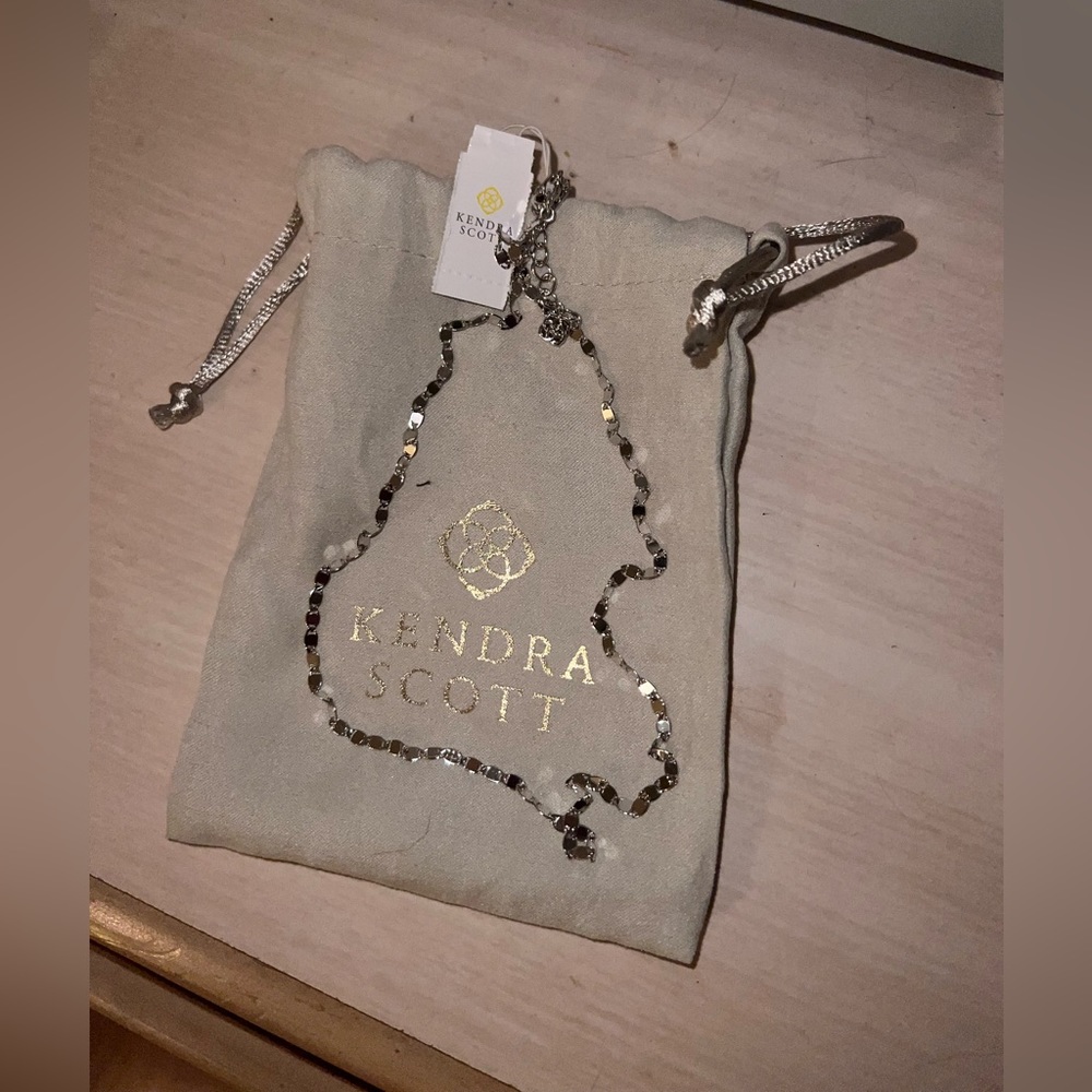 Kendra Scott silver necklace with tags on it